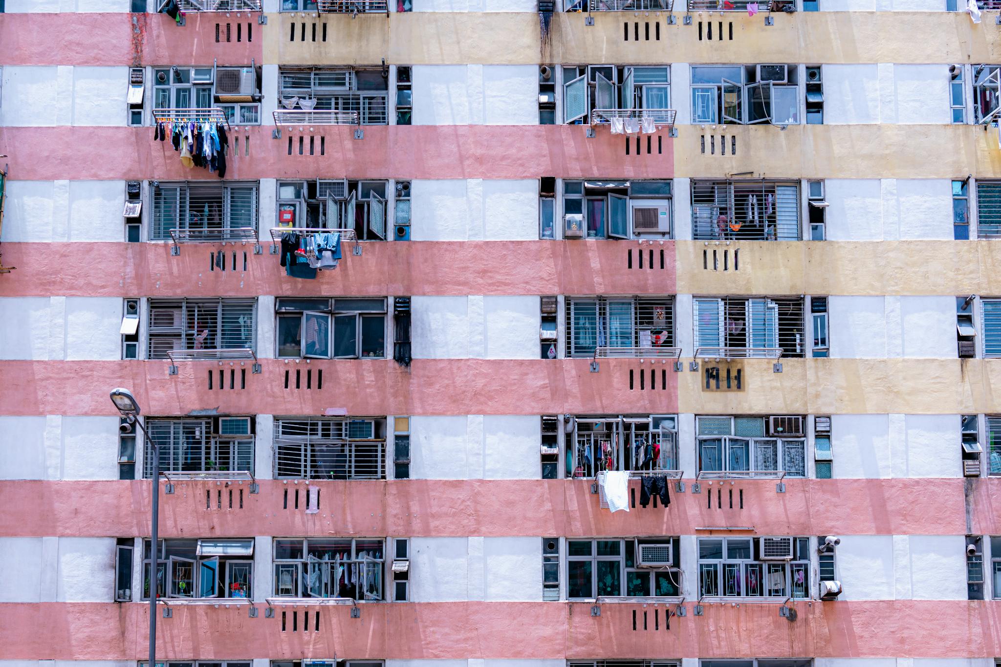 Close-up of a colorful apartment building facade showcasing urban architecture with laundry hanging outside.